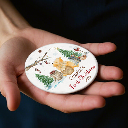 Custom Winnie the Pooh ornament for baby's first Christmas 2025. Features Pooh with hunny pot, winter scene, and space for baby’s name. A charming holiday keepsake for new families.