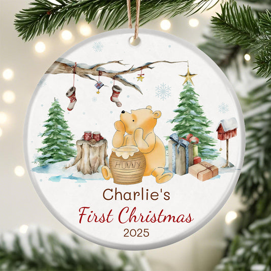 Custom Winnie the Pooh Christmas ornament for baby's first Christmas 2025. Features classic Pooh with hunny pot, winter scene, and personalized name space. Perfect holiday keepsake for new families.