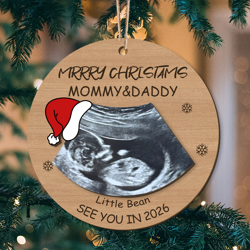 Personalized ultrasound Christmas ornament: "Merry Christmas Mommy & Daddy", "See You in 2026", and Santa hat design. Custom holiday gift for expecting parents, optimized for search engines and customization.