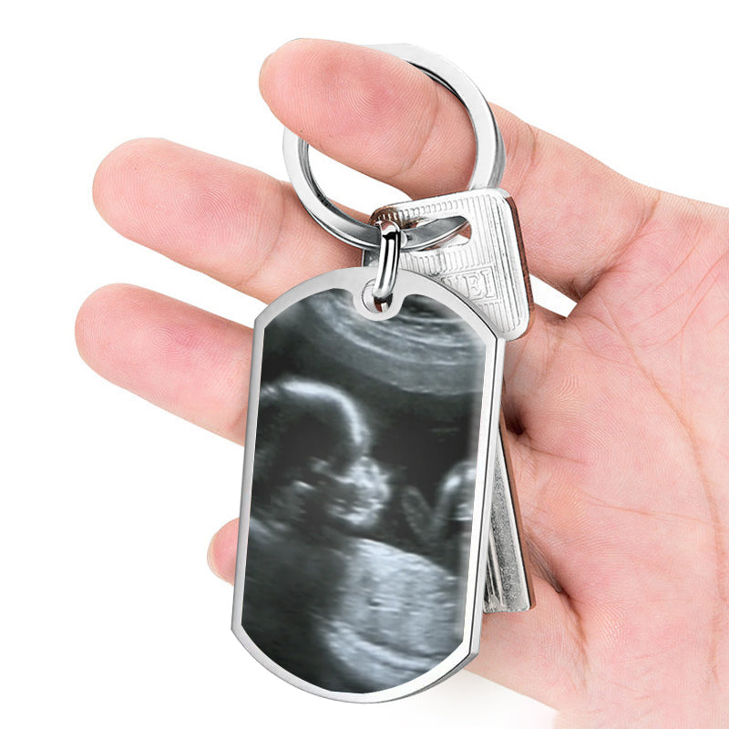 Dad holding personalized ultrasound keychain with dad voice message - unique baby shower present from mom, upload baby’s scan