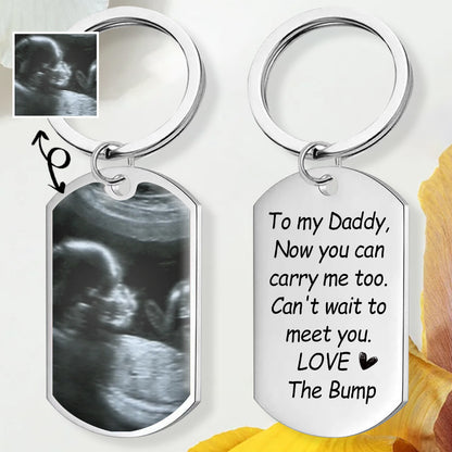 Closeup of custom ultrasound photo keychain - choose mom or dad voice message, customizable baby announcement gift for family